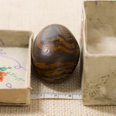 Seer stone associated with Joseph Smith, short side view, and storage box, with metric tape measure