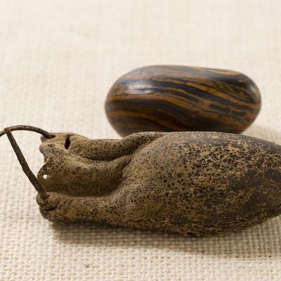 Seer stone associated with Joseph Smith, long side view, and pouch